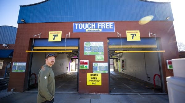 Matt Fisher, owner of the Union Green Car Wash and Dog Wash in Lakewood, stands in front of his business on a warm morning.