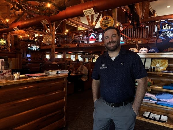 A man posing for a photo in a bar