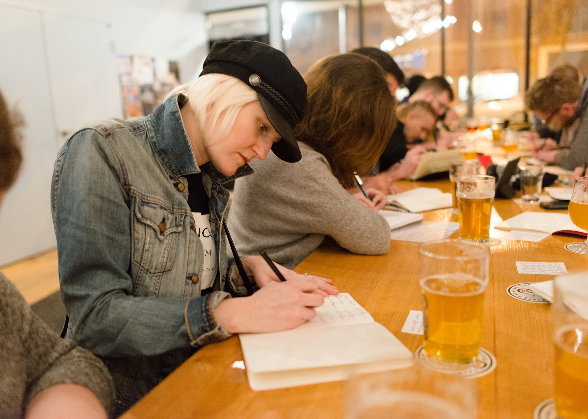 Kristin Brown practices cursive handwriting at Fair State Brewing Coop.