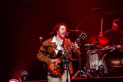 Hozier and band performing on stage