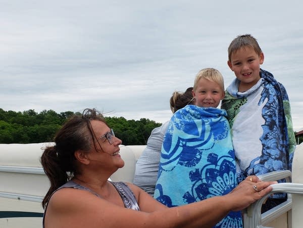 a woman and children on a boat 