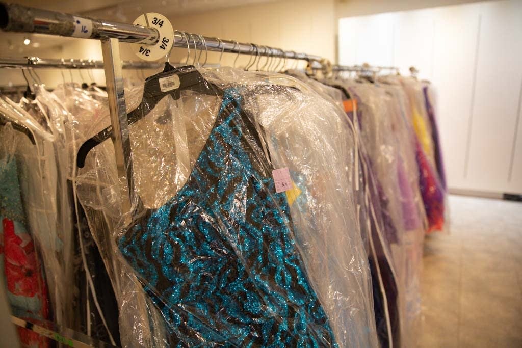 Some of the 3,000 prom dresses are hung in Southdale Center.