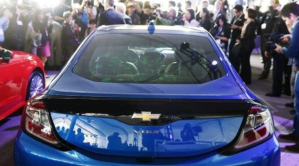 A crowd gathers around a 2016 Chevrolet Volt after it was named 2016 Green Car of the Year, at the 2015 Los Angeles Auto Show in Los Angeles, California, November 19, 2015. 
