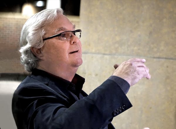 A man conducts an ensemble
