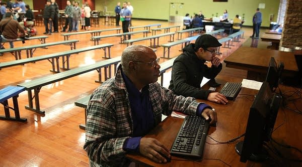 Job seekers use computers to fill out applications during a job fair at California's Great America theme park on February 6, 2015 in Santa Clara, California.