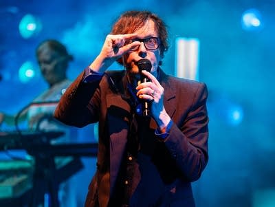 Jarvis Cocker of Pulp pinches two fingers in front of his eye as he performs at Armory.