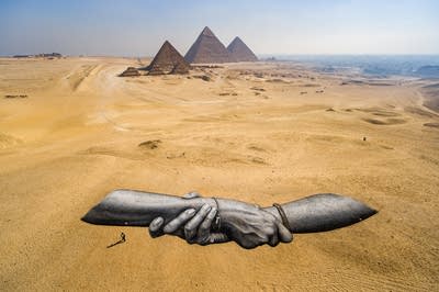A painting of hands clasp together.