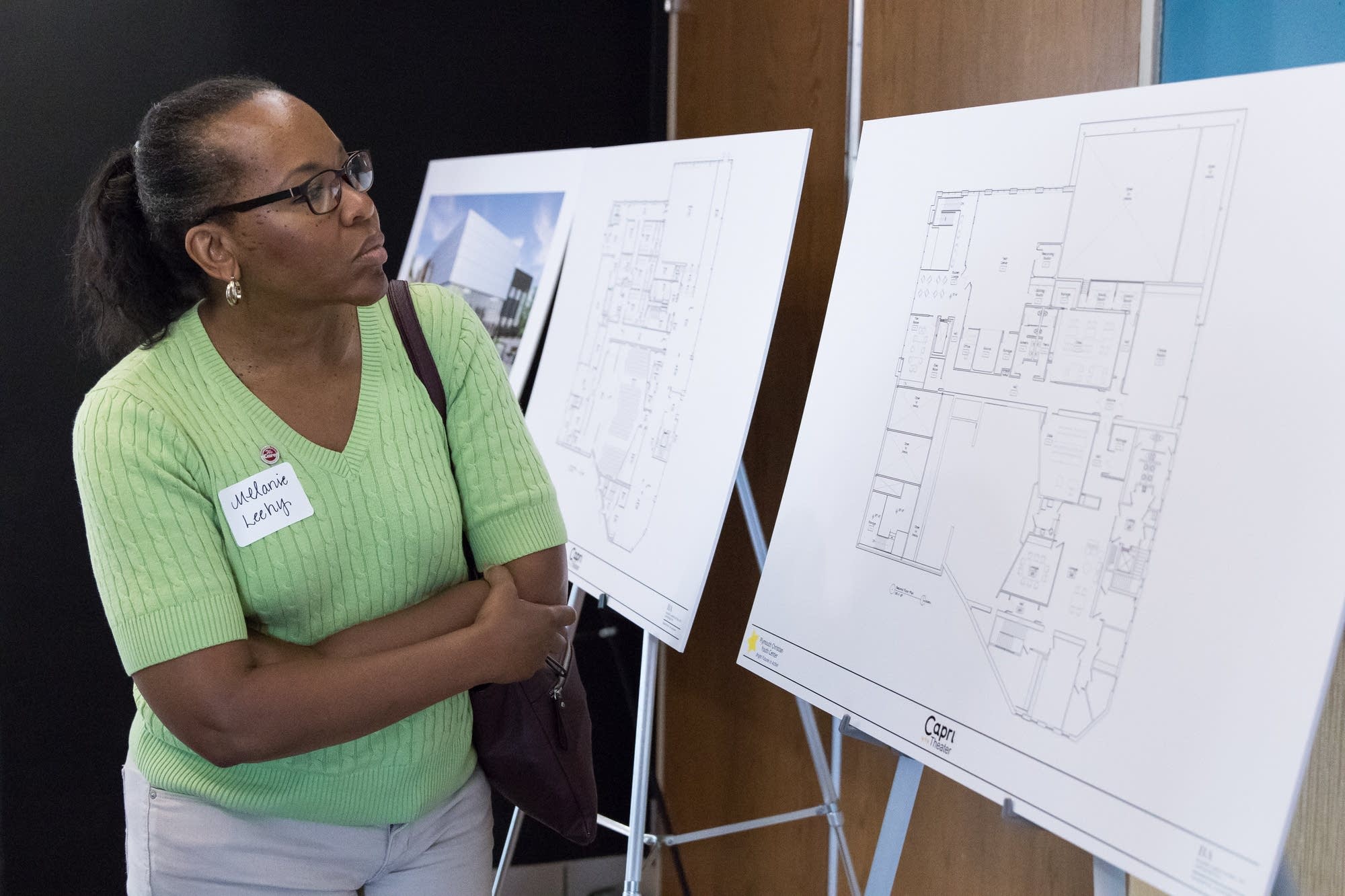Melanie Leehy looks over blueprints for the new Capri Theater.