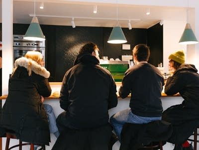 Heights Coffee Bar is a brightly lit shop hosting customers at tables in Columbia Heights, Minnesota.