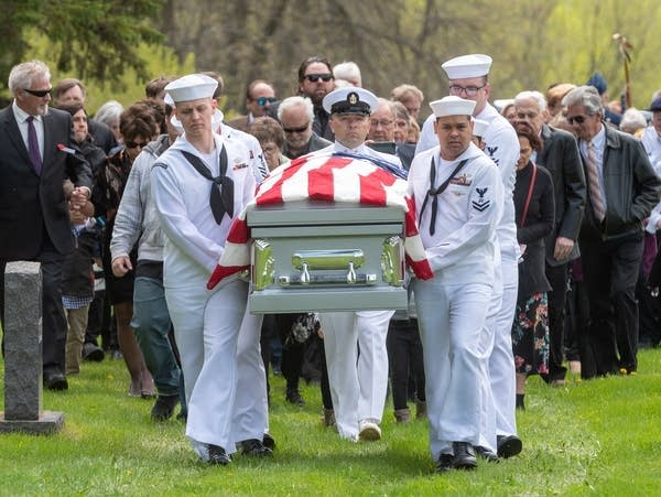 A U.S. Navy honor guard carries the remains of Dante Tini