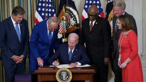 Above, U.S. President Joe Biden signs the Inflation Reduction Act into law in August 2022.