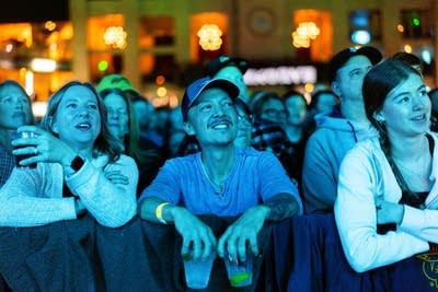 Crowd smiling and and watching performance
