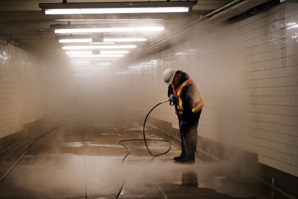 A worker cleans a subway station this week in New York City.