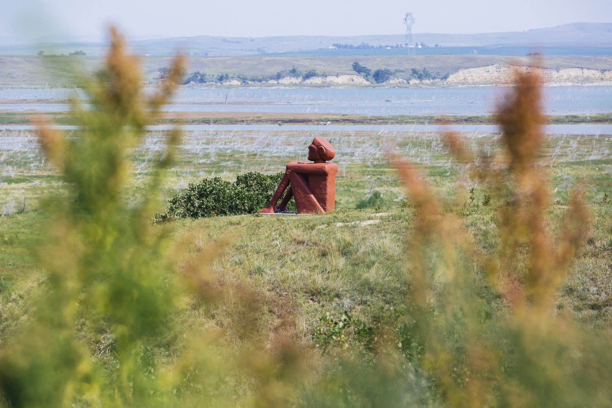 A statue sits overlooking the site of the 3 protest camps.