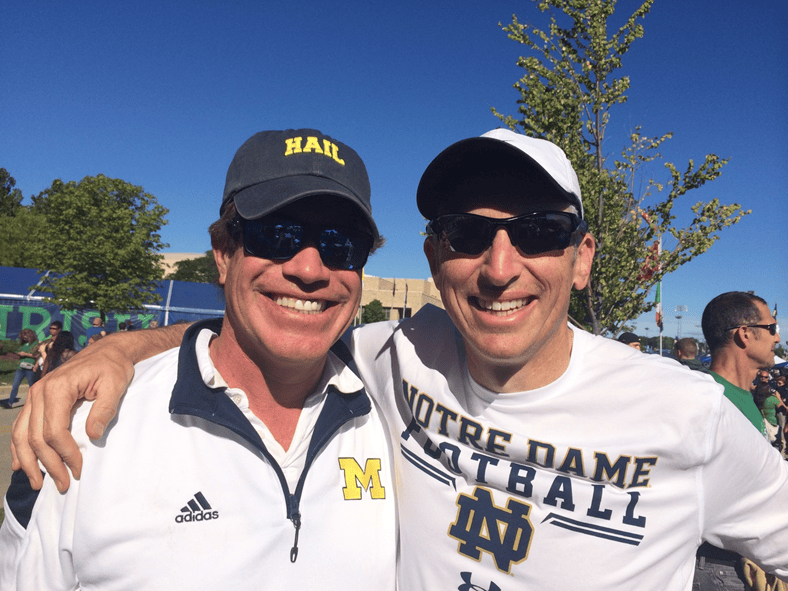 Two men pose for a photo