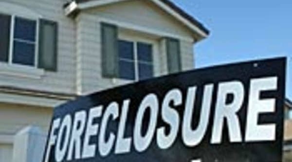 A foreclosure sign in front of a house for sale  in Stockton, Calif.