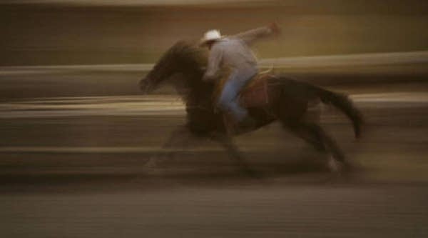 A man trains his horse along the San Gabriel River on July 10, 2004 near the Los Angeles, Calif.