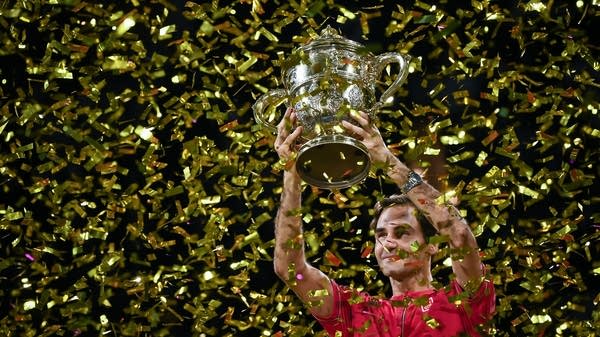 Swiss Roger Federer raises the trophy after his 10th victory at the Swiss Indoors tennis tournament in Basel on October 27, 2019.