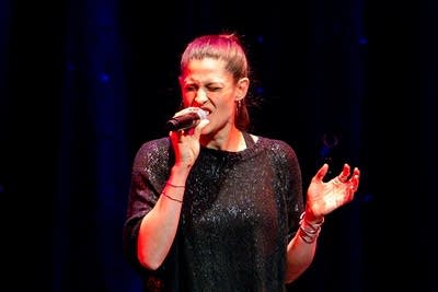 a woman singing on stage