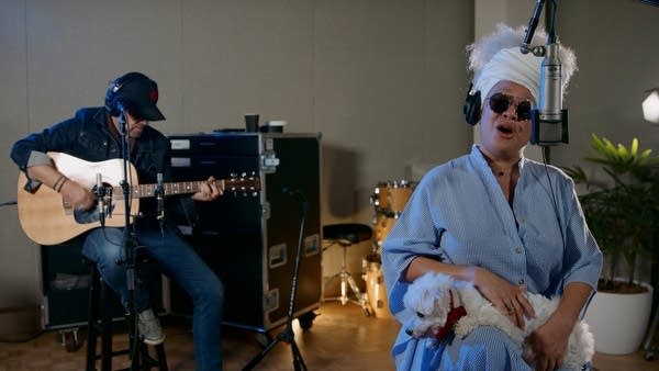 Two musicians performing in a recording studio