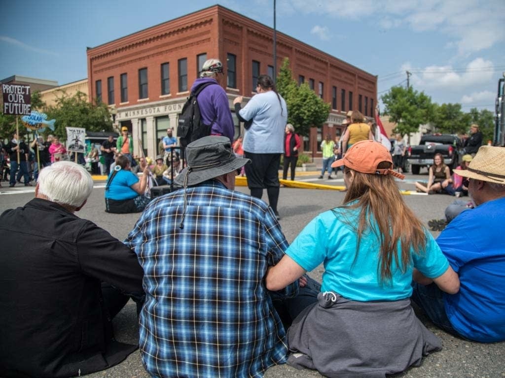 Protesters sit-in at the corner of 3rd Street and Beltrami Avenue.