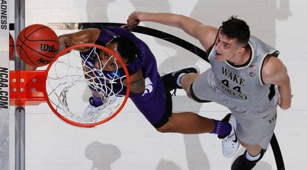 Carlbe Ervin II #1 of the Kansas State Wildcats shoots the ball against Konstantinos Mitoglou #44 of the Wake Forest Demon Deacons during the First Four game in the 2017 NCAA Men's Basketball Tournament.