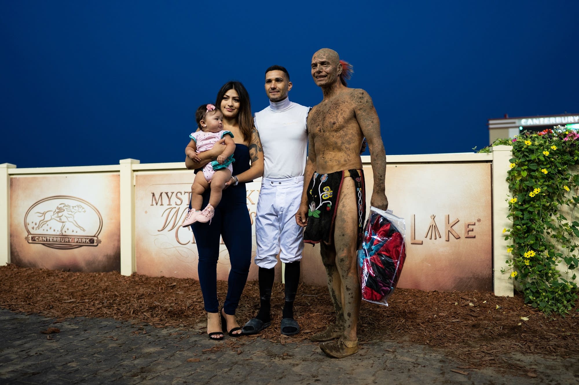 Tim Brown, right, stands for a photo with a racehorse jockey.