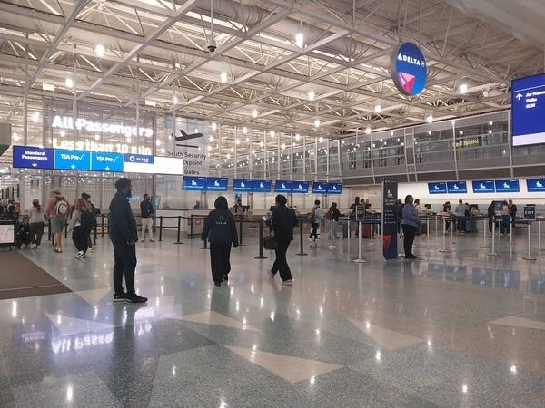 People walk through the airport.
