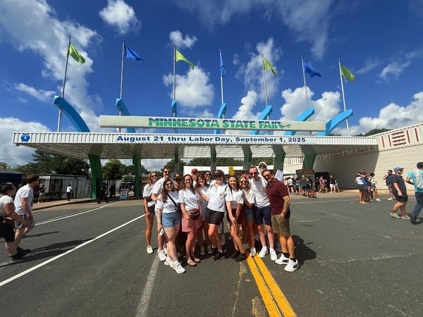 A bachelorette party poses for a photo in front of the Minnesota State Fairgrounds entrance.