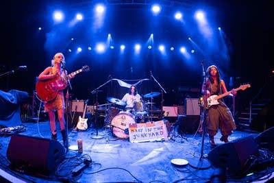 A band performing onstage in a music venue
