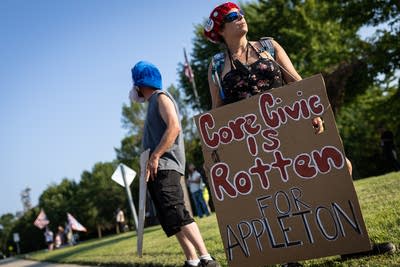 A person holds a protest sign