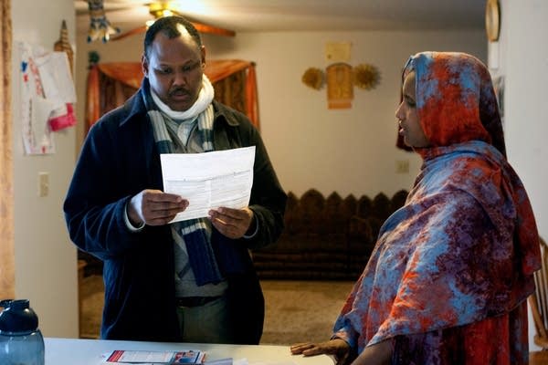 Social worker Abdulahi Mohamed helps Safiya Mohame