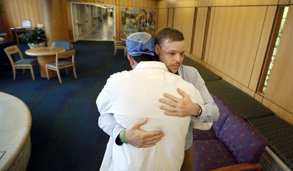 Andy Sandness is hugged by Dr. Samir Mardini