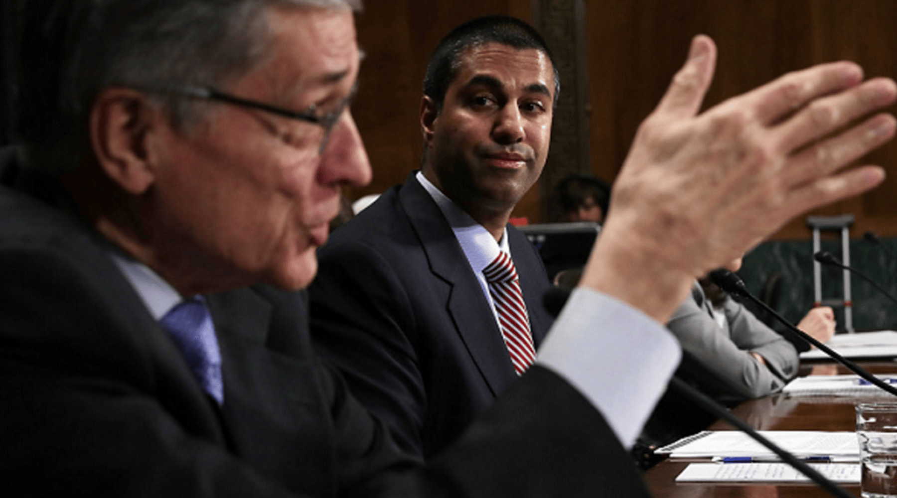  Federal Communications Commission (FCC) Chairman Thomas Wheeler (L) speaks as FCC Commissioner Ajit Pai (R) looks on during a hearing. 