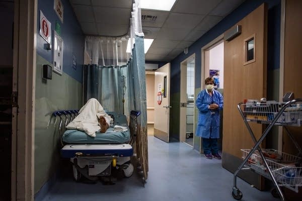 A patient rests in a corridor waiting for a room at Providence Cedars-Sinai Tarzana Medical Center in Tarzana, California, on Jan. 3.