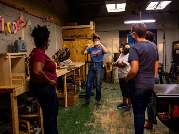 A person demonstrates a wood cutting technique 