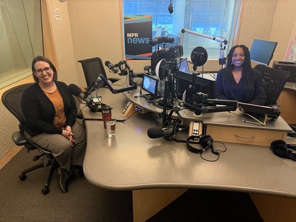 two women smiling in a broadcast studio