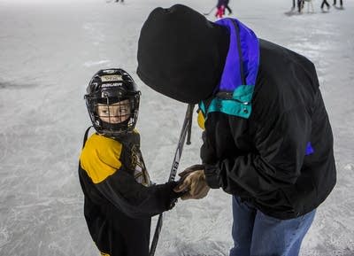 Mike Johnson warms up his grandson's hands.