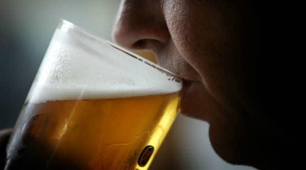 A man drinks a pint of beer in Glasgow, Scotland.