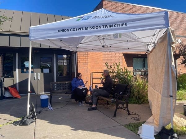 people outside sitting and talking