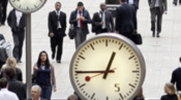 City workers walk through London's Canary Wharf