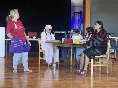 A group of performers are on a page.
