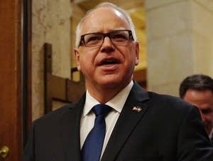Gov. Tim Walz enters the House chambers