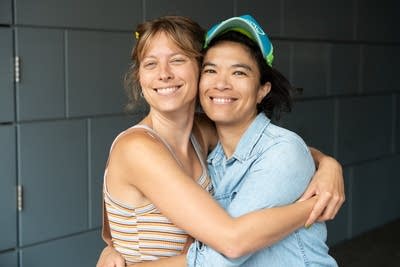 Two women embrace for a portrait