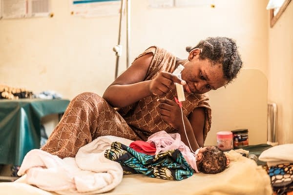 woman feeding her baby