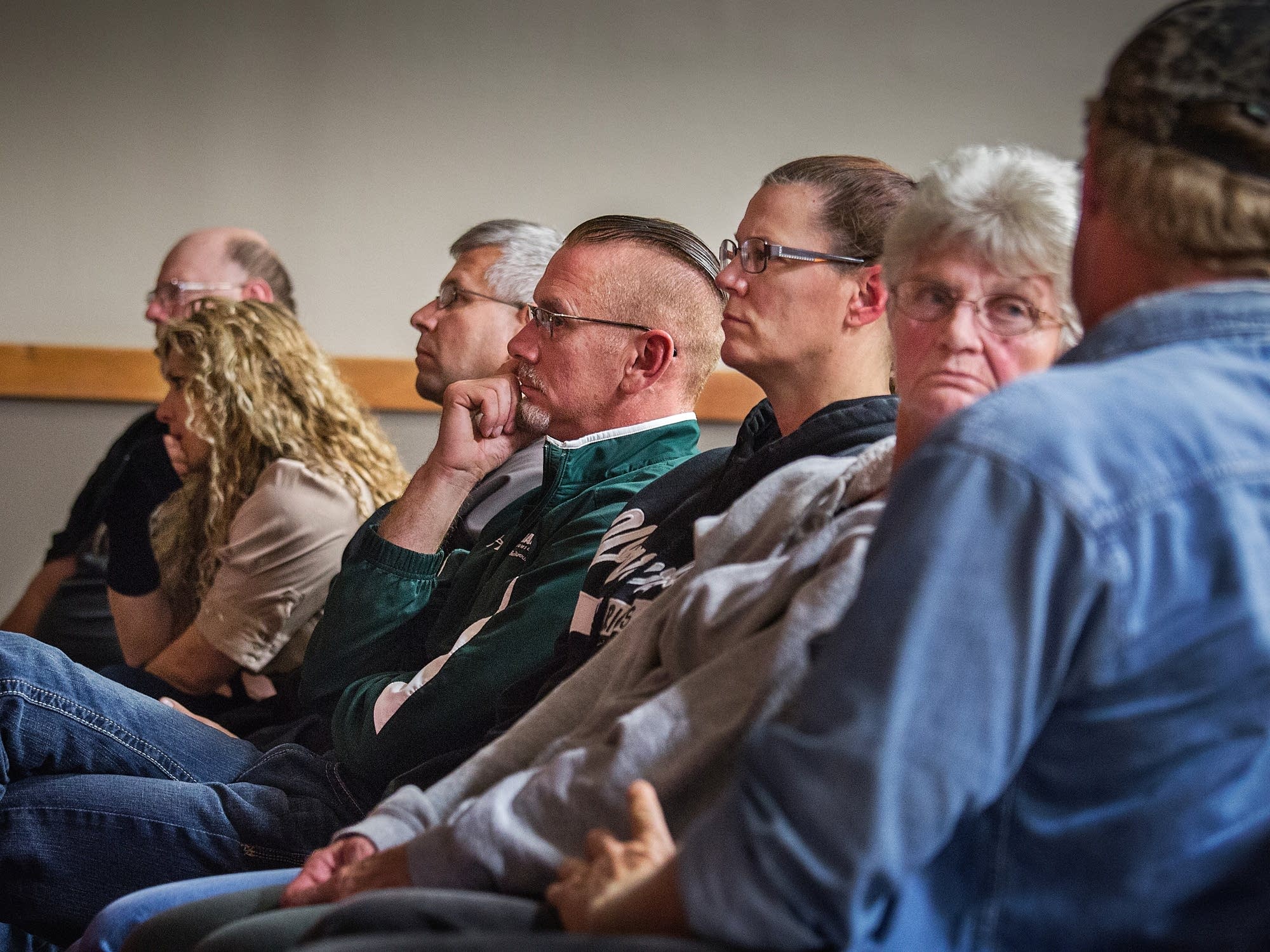 Audience members listen to John Guandolo.