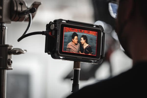 A screen captures two people looking at each other in a video recording.