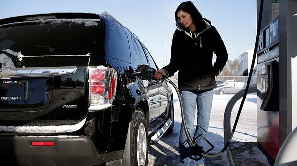 A driver pumps gas at a gas station in Flint, Michigan. 