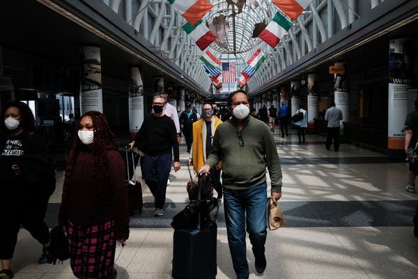 People walk through Chicago O’Hare airport on April 26. 