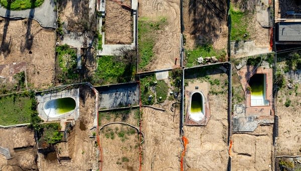 An aerial view shows empty lots and pools in Altadena, California on January 5, 2026.